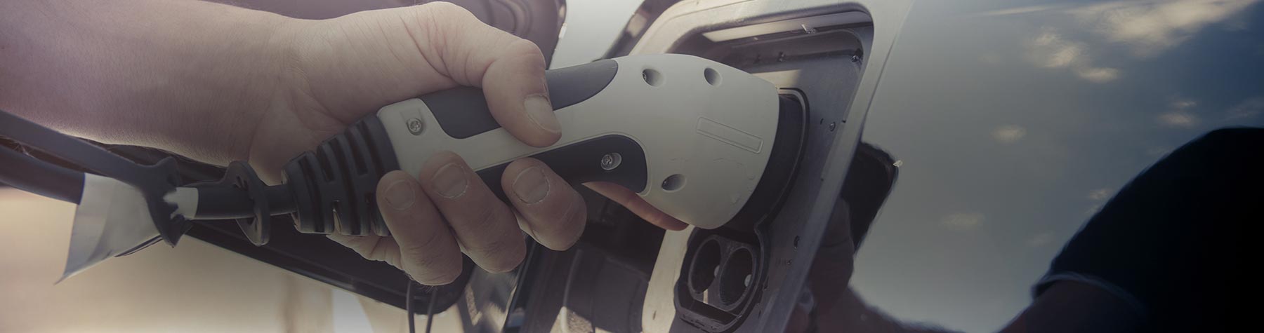 Electric Car Charger Being Plugged In