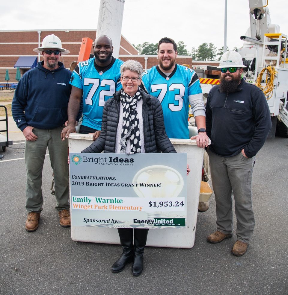 Emily Warne with EnergyUnited Linemen and Carolina Panthers Linemen